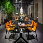 Tan Leather Dining Chair with Dark Wood Frame and Sleek Curved Design